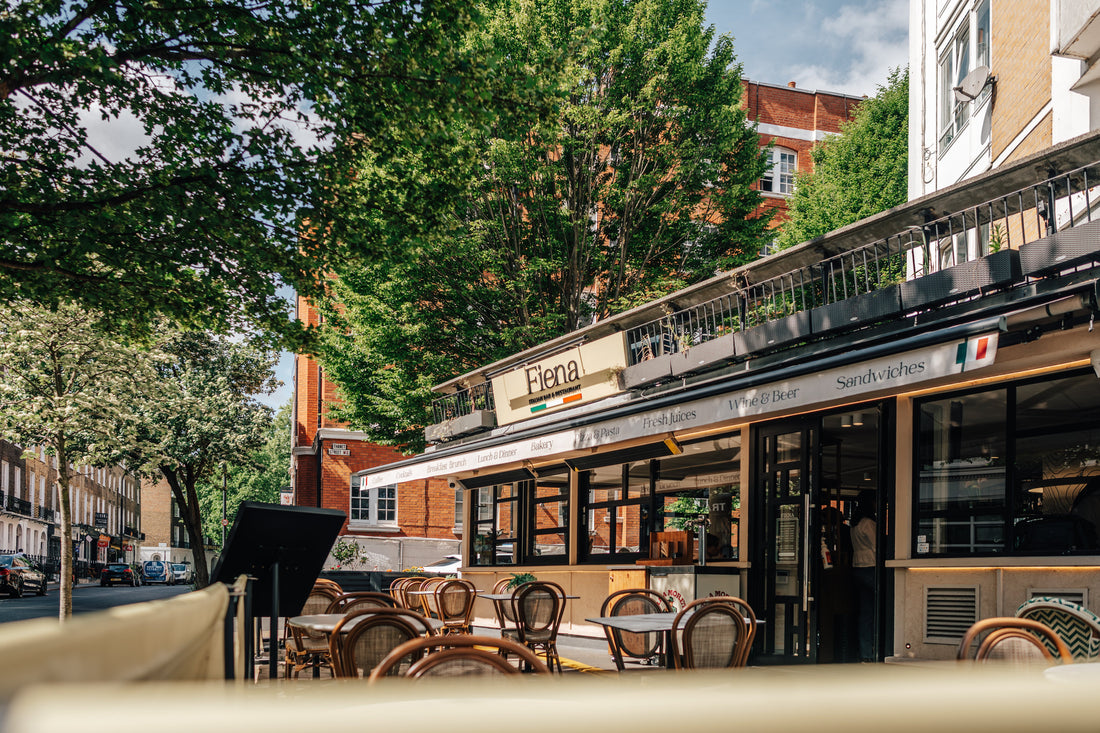 Fiena terrace with bistro tables on tree-lined Judd Street near King's Cross station