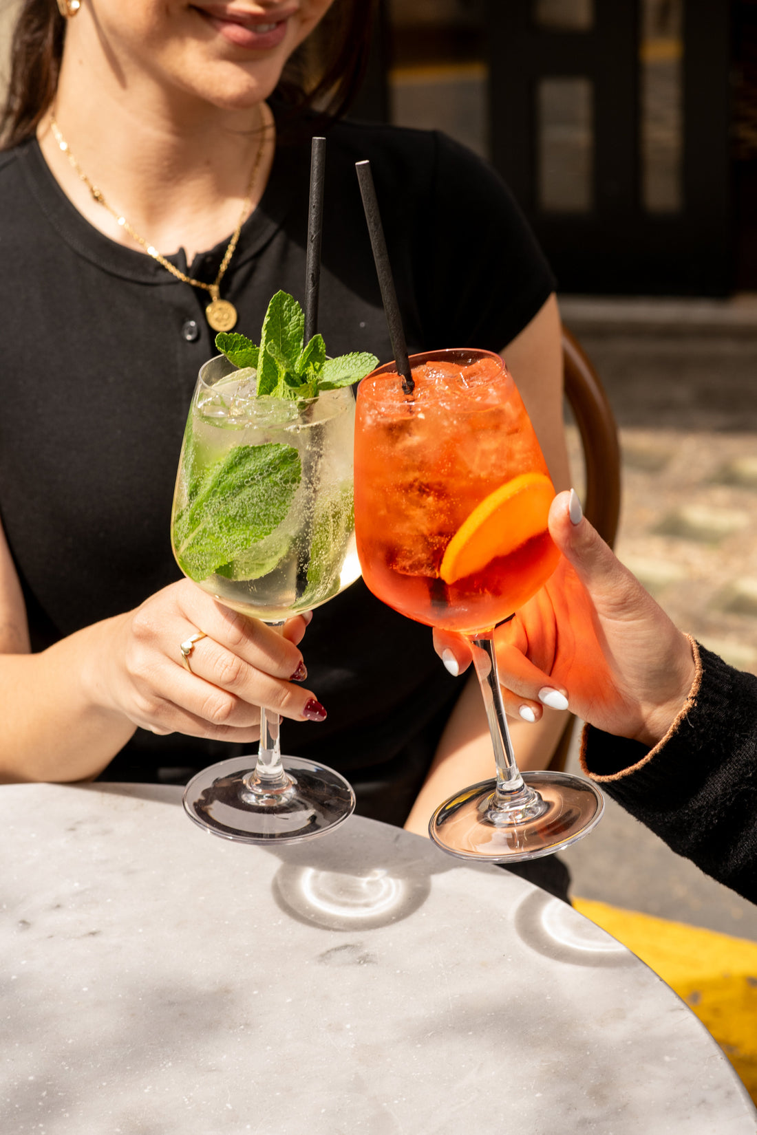 Two spritzes clinking on the terrace at Fiena, King's Cross